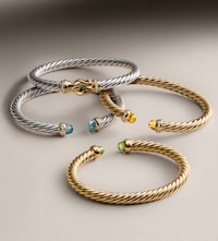 Image of David Yurman bangles on grey background. Tap to Shop Ladies jewellery image