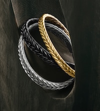 Image of David Yurman bangles on grey background. Tap to Shop Mens jewellery image