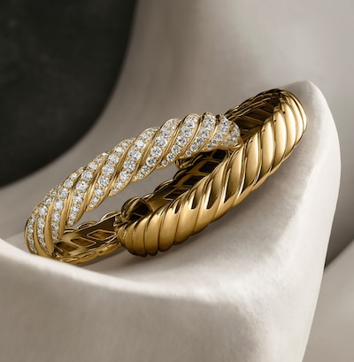 Image of David Yurman Sculpted Cable bangles on grey background. Tap to Shop Ladies jewellery image