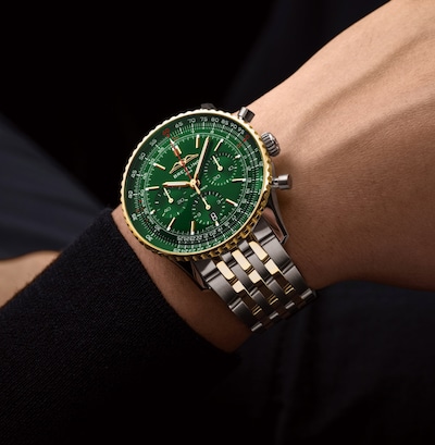 Image of mens wrist wearing Breitling Navitimer B01 Chronograph 43mm Dark Green Dial Mens image