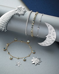 Image of mixed bracelets on silver moon and star background - tap to shop all bracelets image