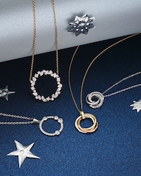 Image of necklaces on blue background - tap to shop all necklaces image
