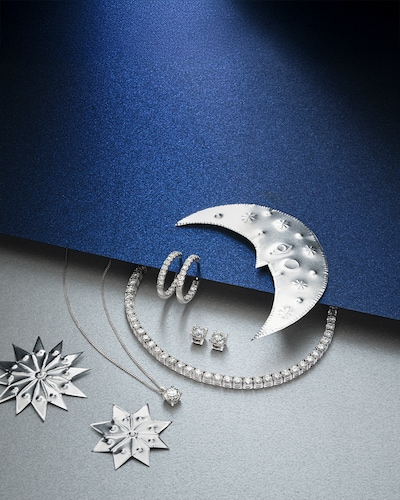 Image of diamond jewellery on blue and silver background with moons and stars - tap to shop all christmas gifts image