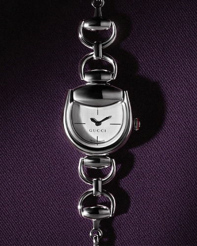 Image of gucci horsebit watch on purple background. tap to shop all gucci watches and jewellery image