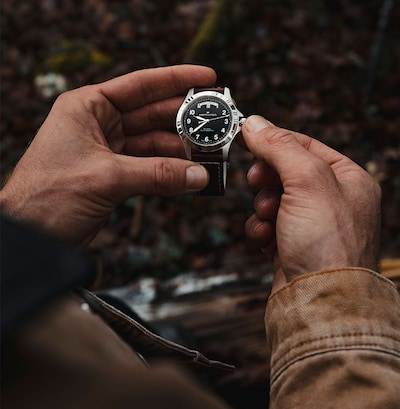 Image of a man holding Hamilton Khakhi Field watch image