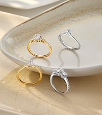 Image of engagement rings in cream ceramic dish. tap to shop all engagement rings image