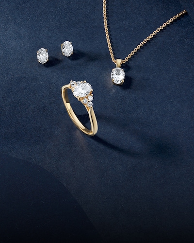 Mappin & Webb Traceable Diamonds with image of necklace, earrings and ring on navy background. Unearthed from four hand-picked countries, chosen for their outstanding ethical standards. image