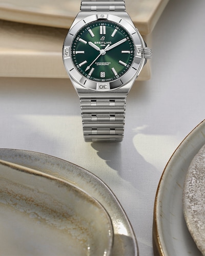 Image of breitling watch in cream ceramic dish. tap to shop all watches image