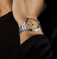 Model wearing Tudor watch - tap to shop all new tudor watches image
