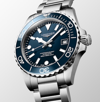 Image of Henry Cavill with Hydroconquest watch with text Elegance is an attitude and Longines logo image
